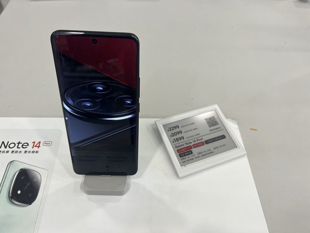 Redmi Note 14 Pro on a display stand