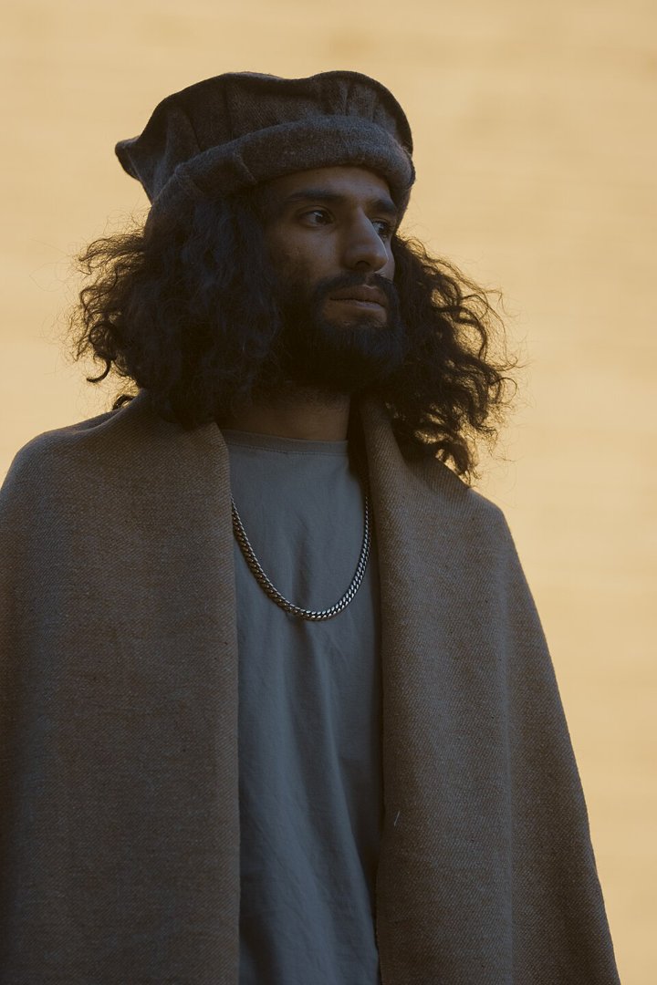 Young man wearing a wool pakol hat